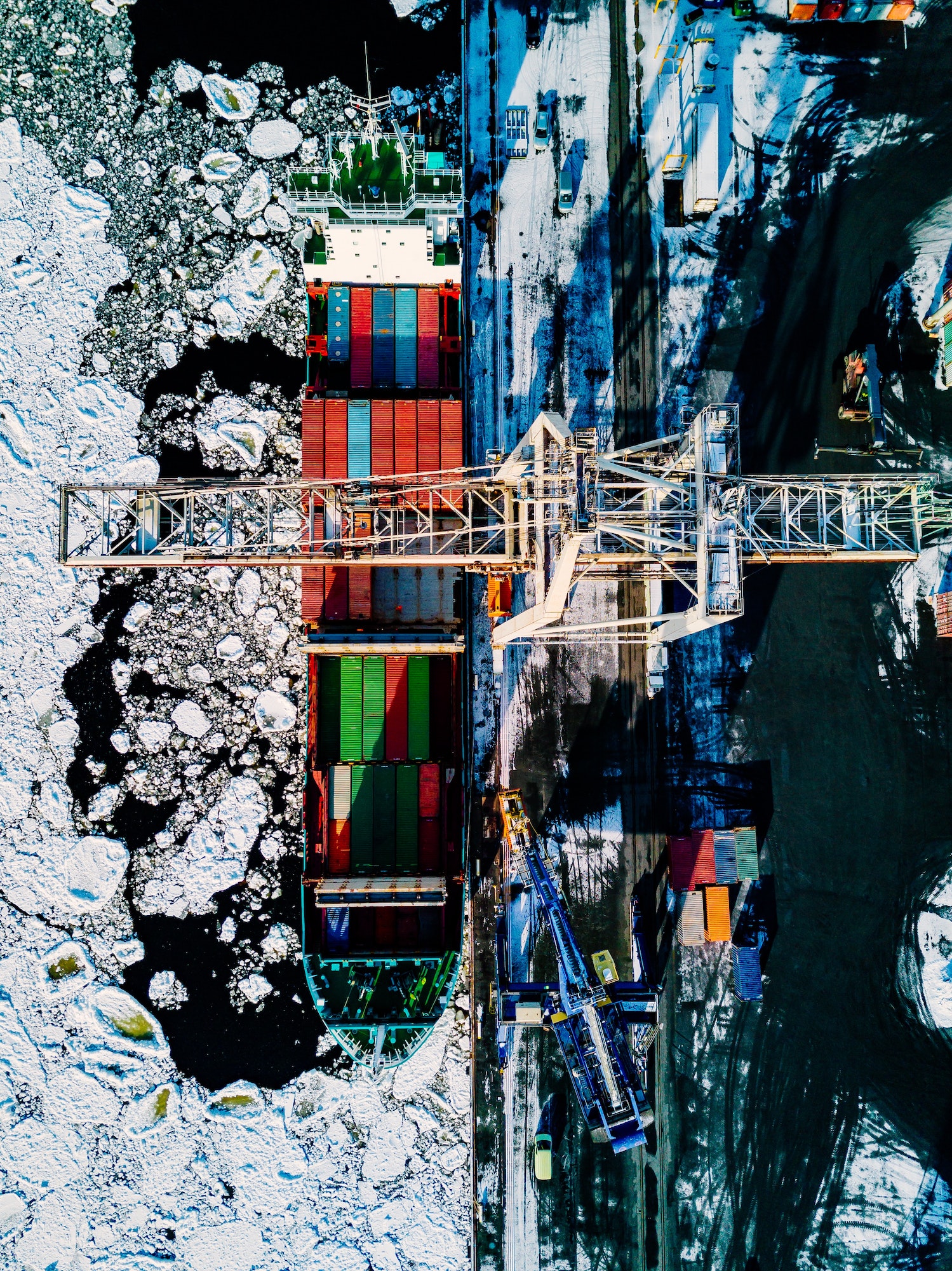 Industrial port with containers in winter, vessel loading
